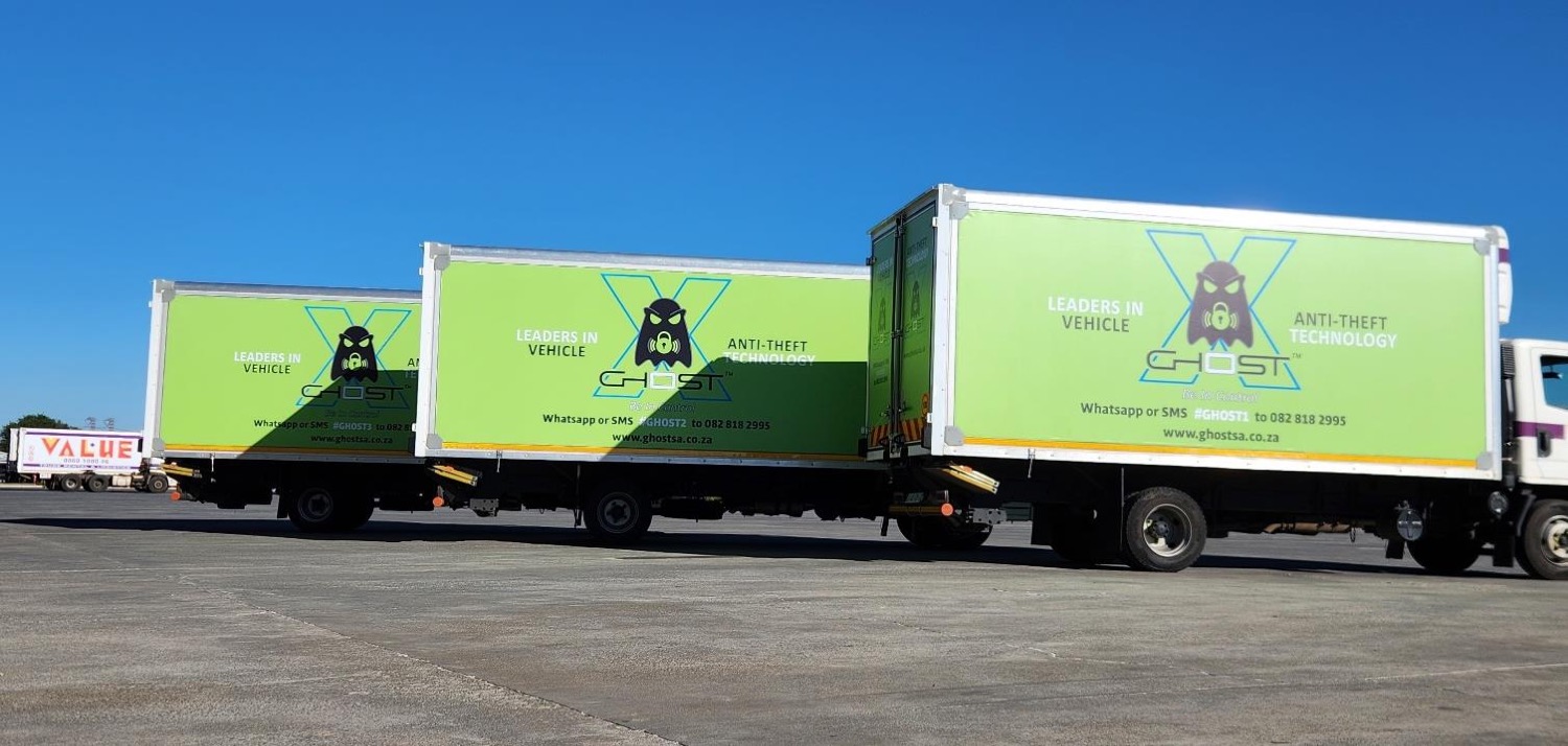 Three Ghost Anti-Theft branded trucks lined up