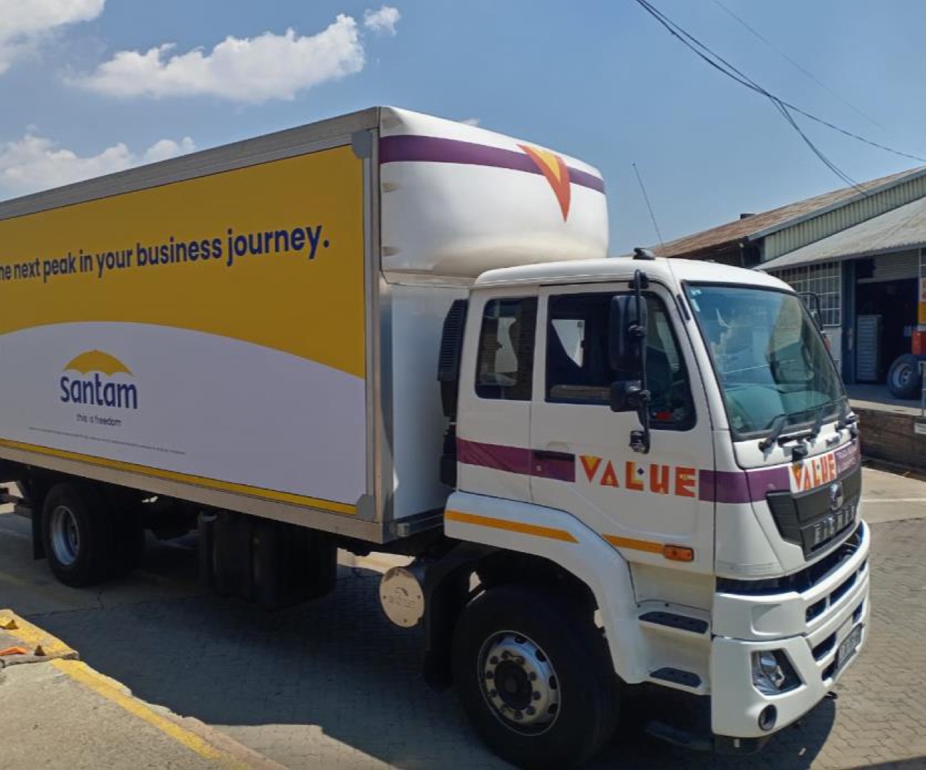 Santam branded 8-ton rigid truck, front three-quarter at depot