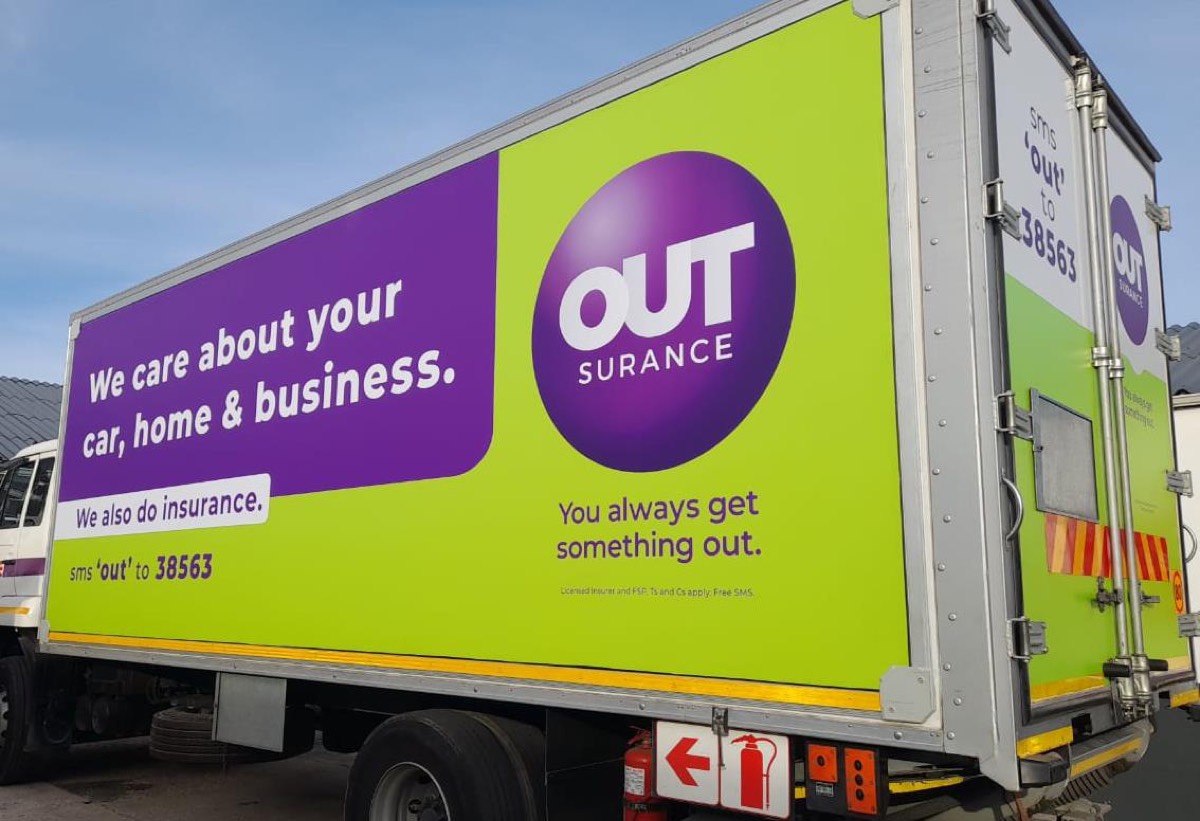 OUTsurance-branded 8-ton rigid truck at a depot