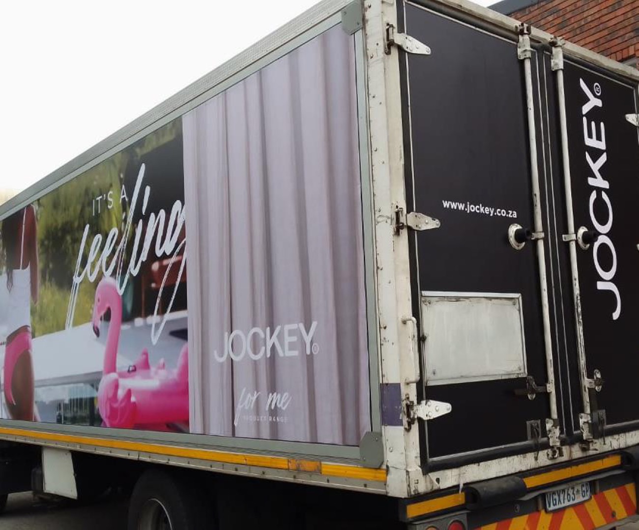 Jockey branded rigid truck, side panel and rear doors at depot